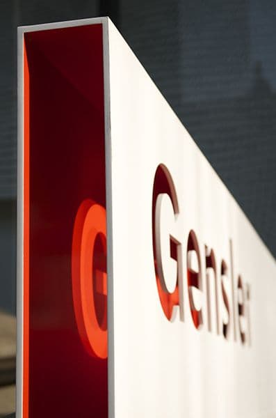 Close-up of red and white branded exterior sign with cut-out typography